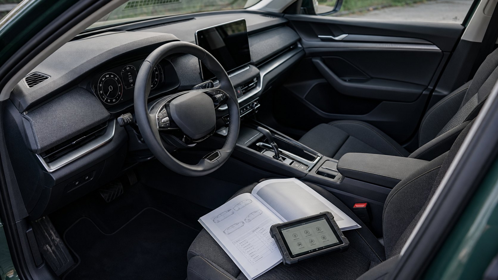 Salon of the car with a manual and a diagnostic tablet